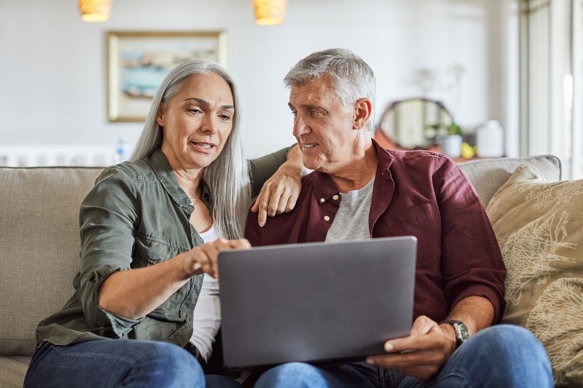 Older couple reviewing retirement information together on a laptop